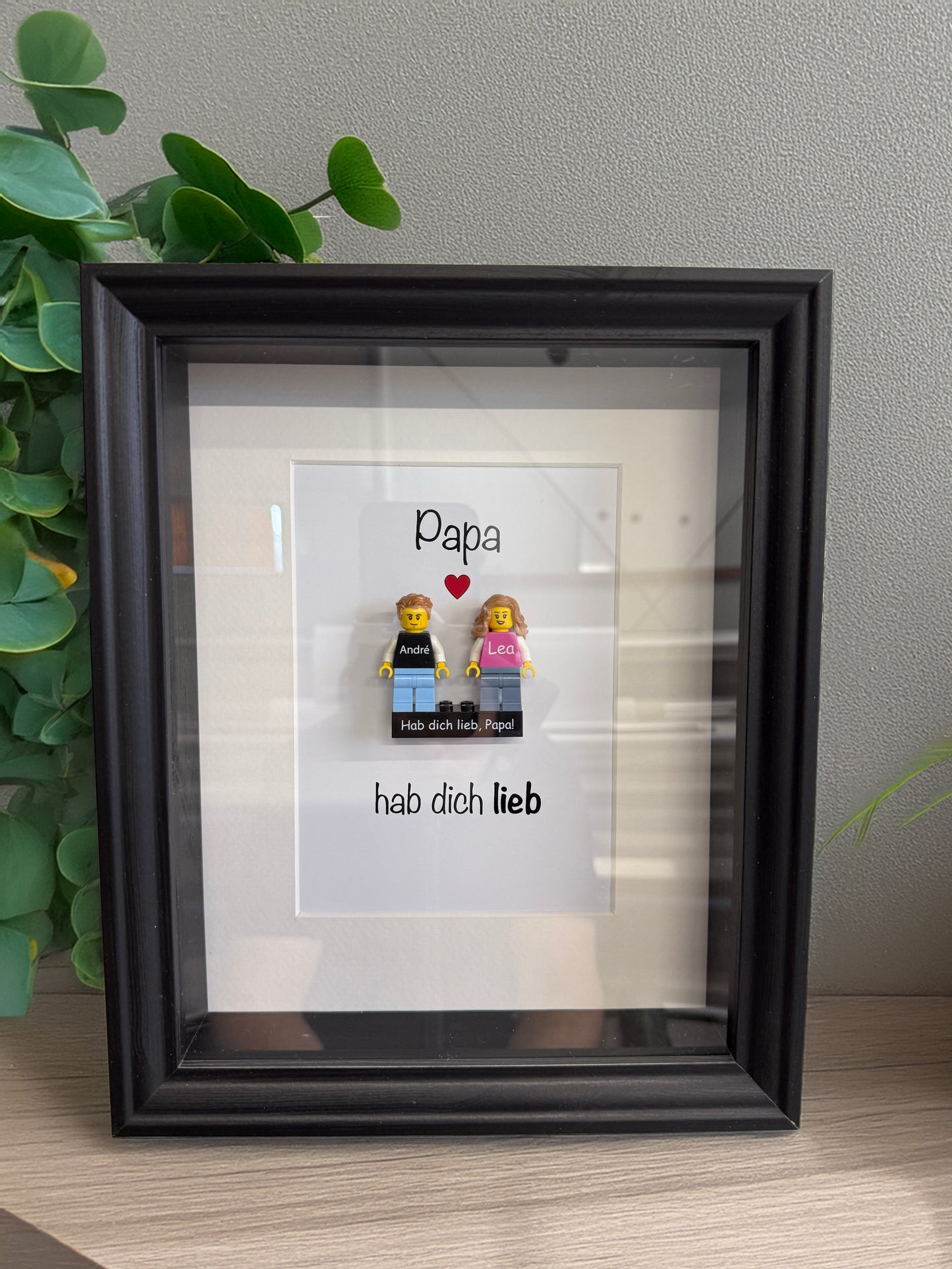Picture frame with personalised LEGO® minifigures on a personalised brick